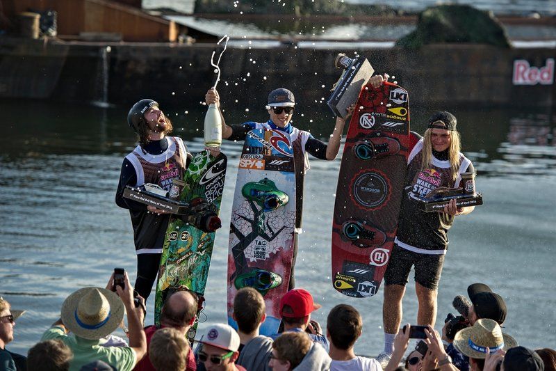 (L-R) Ben Leclair of Canada, Daniel Grant of Thailand and James Windsor of Australia celebrate at the Red Bull Wake of Steel in Linz, Austria on May 21, 2016